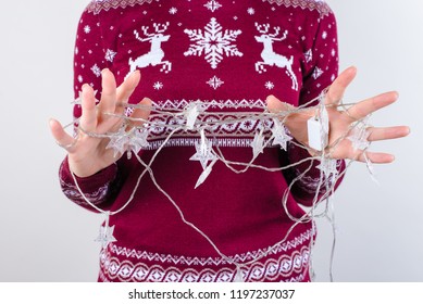 Cropped Close Up Photo Of Angry Sad Upset Crazy Teenager's Hands Trying To Untangle Unravel Christmas Lights Isolated On Grey Background Copy Space