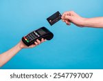 Cropped close up portrait of hands hols pos terminal credit card payment isolated on blue color background