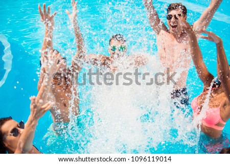 Cropped close up shot of youth going crazy in the pool, splitting water and go insane, huge splashes of blue clear water, guys jump and dabble
ladies, they scream and laugh