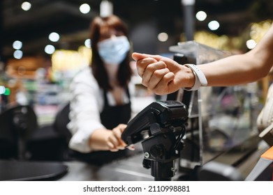 Cropped close up woman hand arm shopping at supermaket put smart watch to modern bank payment terminal process acquire payments near cashier checkout inside store. People lifestyle purchasing concept - Shutterstock ID 2110998881