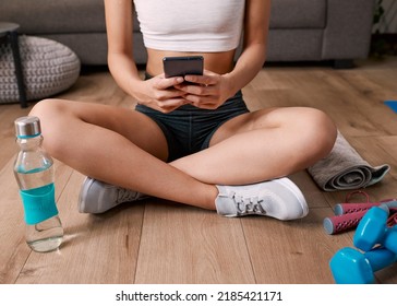 Cropped Close Up Of Young Woman On Cellphone Post Workout