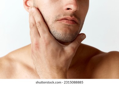 Cropped close-up image of male face with bristle against white studio background. Shaving. Concept of men's beauty, skincare, cosmetology, spa, health. Copy space for ad - Powered by Shutterstock