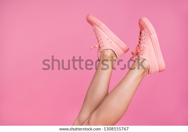Cropped close-up image view\
photo of nice attractive feminine fit thin slim shaven legs active\
sport walk go steps trendy foot-wear isolated over pink pastel\
background