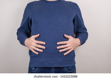 Cropped Close-up Photo Of Satisfied Happy Positive Funny Funky Guy Touching Holding Hands Of Full Stomach Isolated Grey Background