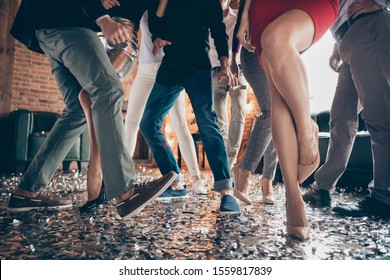 Cropped closeup photo of slim tender legs girls guys meeting rejoicing dance floor x-mas party glitter flying wear luxury formalwear red dress silver skirt pants restaurant indoors