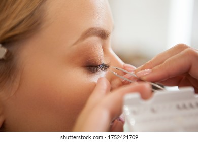 Cropped Closeup Of A Professional Makeup Artist Applying False Lashes On The Eyes Of A Woman