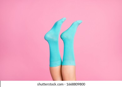 Cropped close-up view of nice attractive lovely prefect legs wearing bright blue soft comfortable socks 8 March day holiday sale discount isolated over pink pastel color background