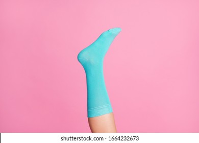 Cropped Close-up View Of One Nice Single Leg Wearing Blue Soft Cotton Bright Sock Isolated Over Pink Pastel Color Background