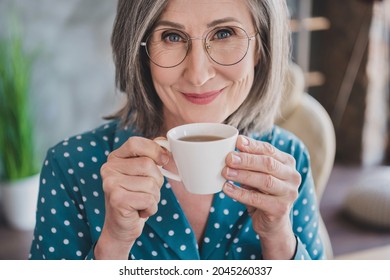 Cropped close-up view portrait of attractive smart cheerful woman drinking espresso at office work station place indoor