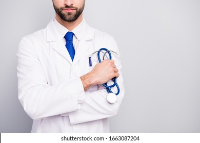 Cropped close-up view portrait of his he nice attractive focused doc surgeon holding in hand tool equipment isolated on light white gray pastel color background