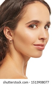 Cropped Detail Shot Of A Charming Brown-haired European Lady With A Golden Stud Earring In The Form Of Gem Crown With Crystals, Gems And A Shimmering Pearl.