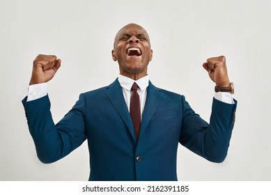 Cropped of excited black confident entrepreneur celebrating his win or success. Bald adult man wearing formal wear. Modern male lifestyle. Isolated on white background. Studio shoot. Copy space - Powered by Shutterstock