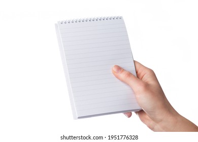 Cropped female hand holds a blank notepad with copy space, isolated on white background