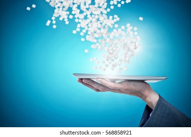 Cropped hand of businessman holding digital tablet against blue vignette background 3d - Shutterstock ID 568858921