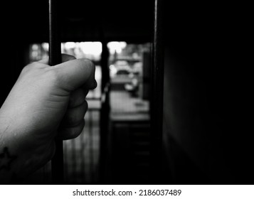 Cropped Hand Of Person Holding Metal Bars