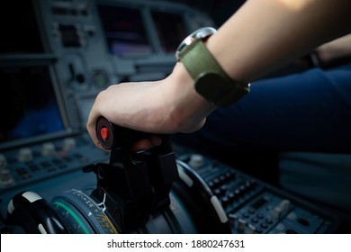 Cropped Hands Of Pilot Flying A Commercial Airplane, Cockpit View Close Up Of Hands. Captain Hand Accelerating On The Throttle In Commercial Airplane. Selective Focus.