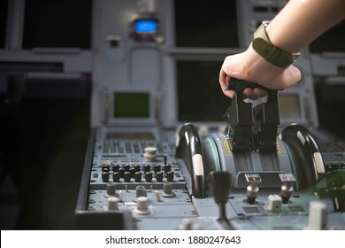 Cropped Hands Of Pilot Flying A Commercial Airplane, Cockpit View Close Up Of Hands. Captain Hand Accelerating On The Throttle In Commercial Airplane. Selective Focus.