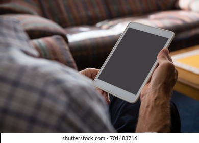 Cropped Hands Of Senior Man Using Tablet Computer While Sitting In Nursing Home