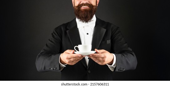 Cropped Happy Man In Tuxedo Bow Tie With Coffee Cup. Waiter In Formalwear Serving Coffee