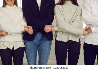 Cropped Happy Young Mixed Race Business People Or Loyal Company Employees Standing Together And Holding Hands. Concept Of Unity, Teamwork, Team Spirit, Strong Community, Mutual Help And Support