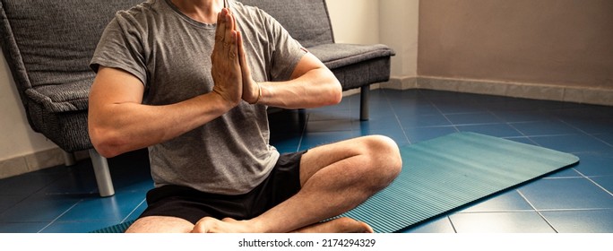 Cropped Image A Adult Caucasian Man At Home In The Yoga Position Of The Liberation. Quarantine Training At Home, Fitness, Meditation And Healthy Lifestyle Concept. Horizontal Banner.