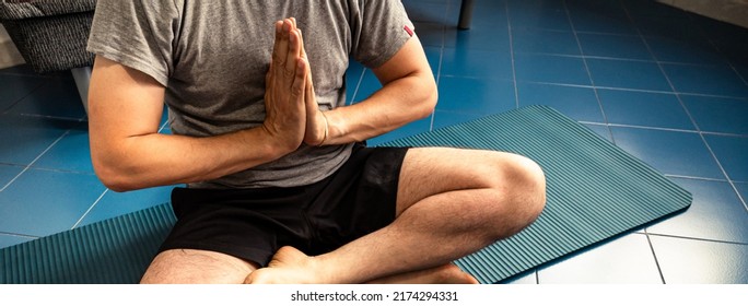 Cropped Image A Adult Caucasian Man At Home In The Yoga Position Of The Liberation. Quarantine Training At Home, Fitness, Meditation And Healthy Lifestyle Concept. Horizontal Banner.