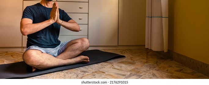 Cropped Image A Adult Caucasian Man At Home In The Yoga Position Of The Liberation. Quarantine Training At Home, Fitness, Meditation And Healthy Lifestyle Concept. Horizontal Banner.