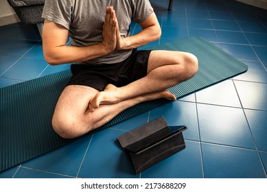 Cropped Image A Adult Man At Home In The Yoga Position Of The Liberation Seen On A Tablet. Quarantine Training At Home, Fitness, Meditation And Healthy Lifestyle Concept.
