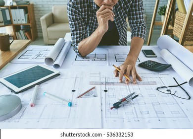 Cropped image of architect working with construction plans - Shutterstock ID 536332153
