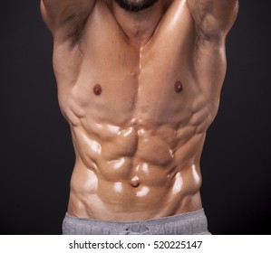 Cropped Image Of Athletic Man Showing Sixpack Abs Over Black Background