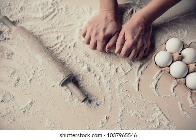 Cropped Image Of Attractive Senior Woman Is Cooking On Kitchen. Grandmother Making Tasty Baking. Close-up Of Women's Hands Making Dough.