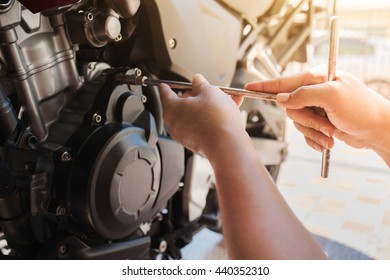 Cropped image of automobile mechanic repairing 
motorcycle in automobile store
 - Powered by Shutterstock