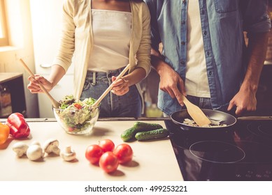 Cropped Image Of Beautiful Young Couple Cooking In Kitchen At Home