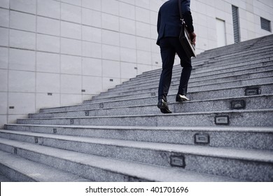 Cropped Image Of Business Person Going Up The Stairs