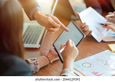 Cropped image of business team planning business strategy together on digital portable tablet in meeting room. tablet mockup - Shutterstock ID 2044129391