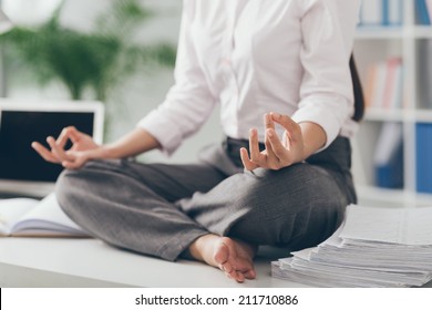 Cropped Image Of Business Woman Practicing Yoga In The Office