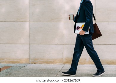 Cropped image of businessman with coffee and magazine going to work - Powered by Shutterstock