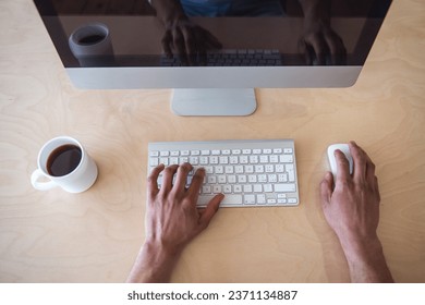 Cropped image of businessman using a computer while working in office