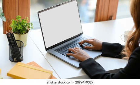 Cropped image of a businesswoman typing on a laptop keyboard. Female student doing her online assignment on notebook computer.