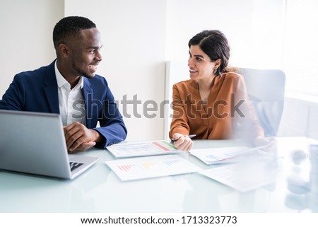 Cropped Image Of Businesswoman Writing On Graph At Desk In Office 