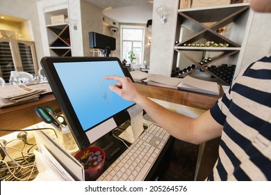 Cropped Image Of Cashier Touching Computer Screen At Restaurant Counter