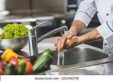 cropped image of chef washing hands at restaurant kitchen - Shutterstock ID 1051945790