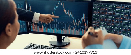 A cropped image of cooperate skilled business team discussion about stock investment while point the analysis stock chart. Show up and down trend. Stock market trading concept. Closeup. Burgeoning.