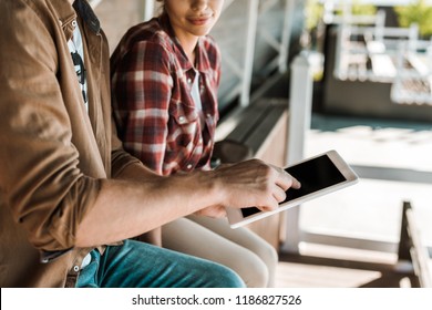 cropped image of cowboy and cowgirl using tablet with blank screen at ranch - Powered by Shutterstock