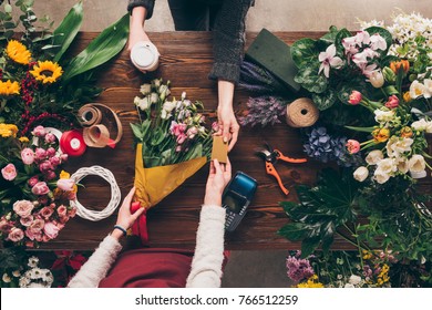 Cropped Image Of Customer Giving Florist Credit Card To Pay For Bouquet 