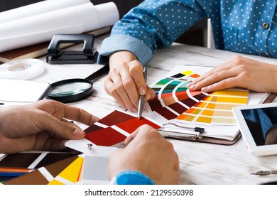 Cropped image of designer and client meeting in office. Creative workspace with color swatches and tablet computer. Interior and textile designing. Coloristics and product branding in design studio. - Shutterstock ID 2129550398