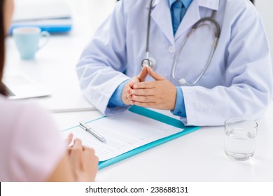 Cropped image of doctor informing female patient of diagnosis