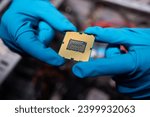 Cropped image of an engineer showing a computer microchip on the foreground