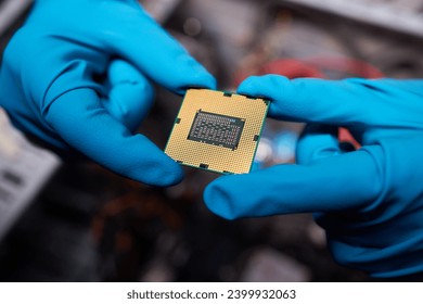 Cropped image of an engineer showing a computer microchip on the foreground