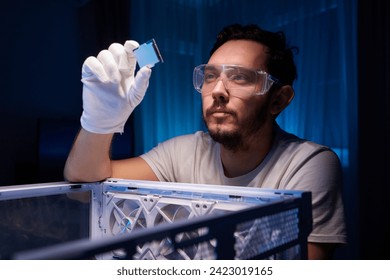 Cropped image of an engineer showing a computer microchip on the foreground